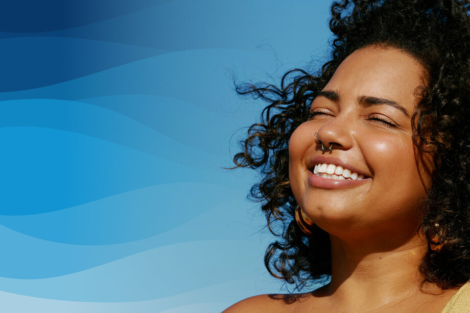A woman happily smiling with closed eyes